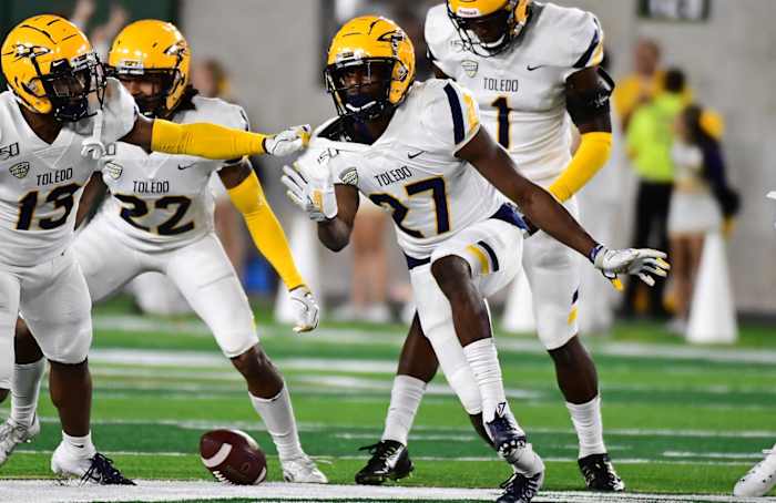 Sep 21, 2019; Fort Collins, CO, USA; Toledo Rockets defensive back Kahlil Robinson (27) reacts to his interception with cornerback Chris McDonald (13) and (22)cornerback Jordan Hendy (22) and defensive back Tycen Anderson (1) in the second quarter against the Colorado State Rams at Sonny Lubrick Field at Canvas Stadium. Mandatory Credit: q